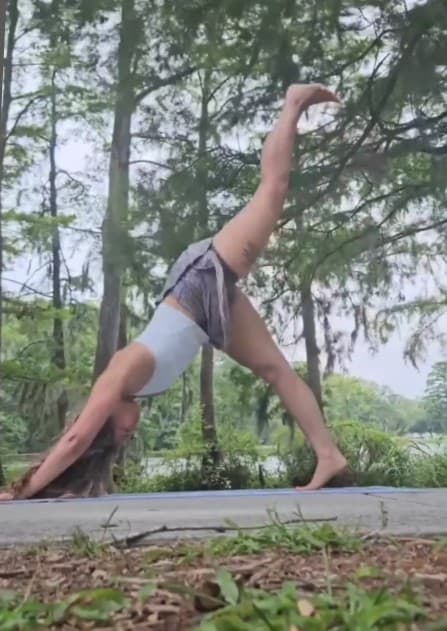 Person doing a downward dog split yoga pose.
